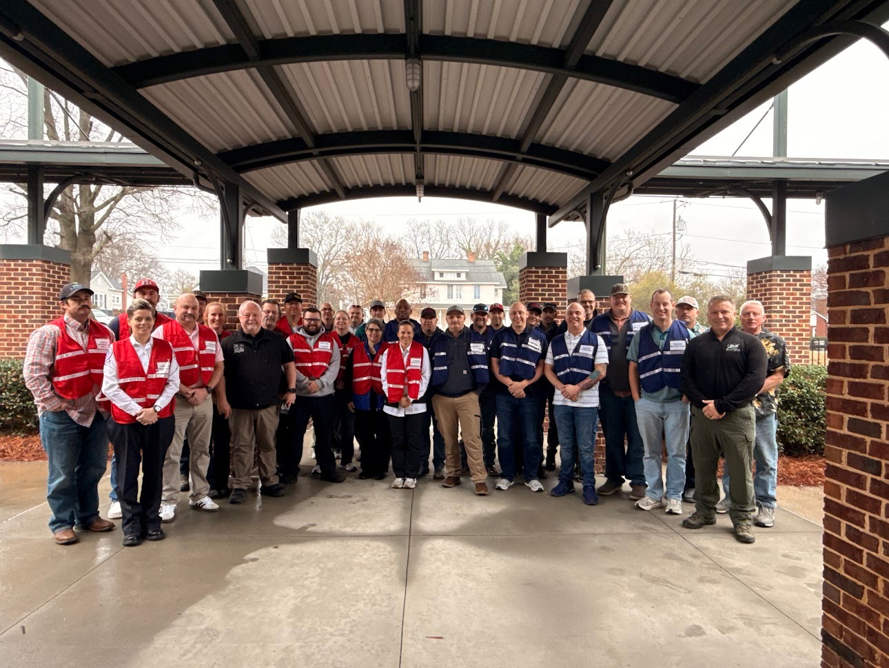 Group of people standing together for a photo outside 